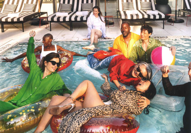 Guests in the rooftop pool, dressed in bright colours and smiling with great city views in the background.