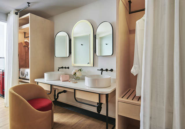 Suite vanity with luxury amenities and his and her sinks at Virgin Hotels.