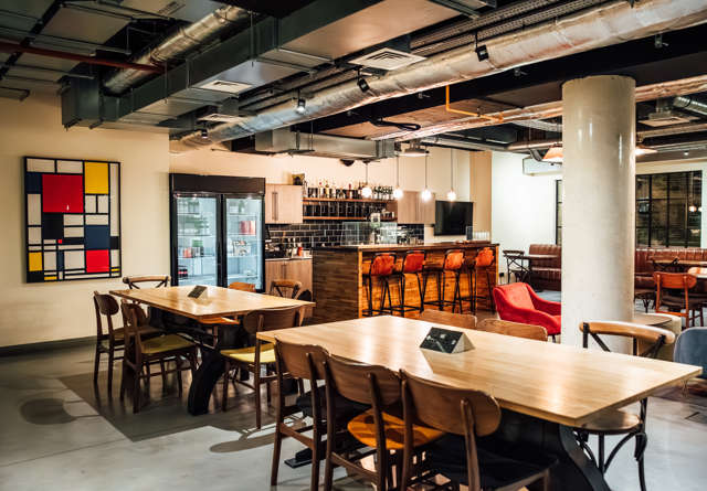 Dining area with large tables, perfect for gatherings at Virgin Hotels.