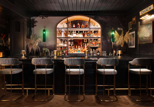 Bar with lit up shelving at the Late Great inside Virgin Hotels Nashville.