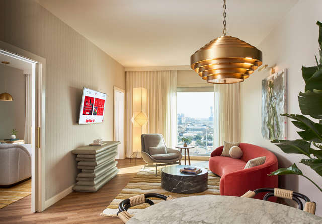 Lounge area in a Deluxe Chamber King Suite with a contemporary design, city views and cozy atmosphere.