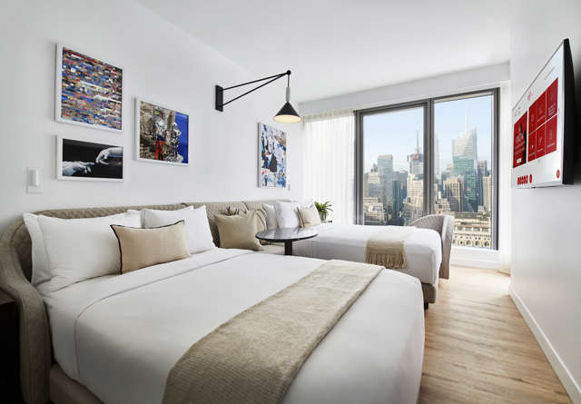 Chamber Double room in Virgin Hotels New York with two beds, contemporary decor, and large windows.