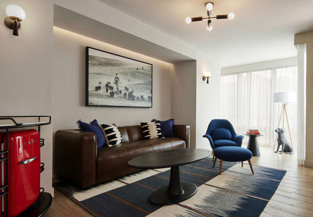 Spacious suite living room with plush seating at Virgin Hotels.